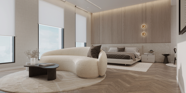 Luxury bedroom with curved textured sofa on a round rug amid herringbone wood floors and wood paneled walls.