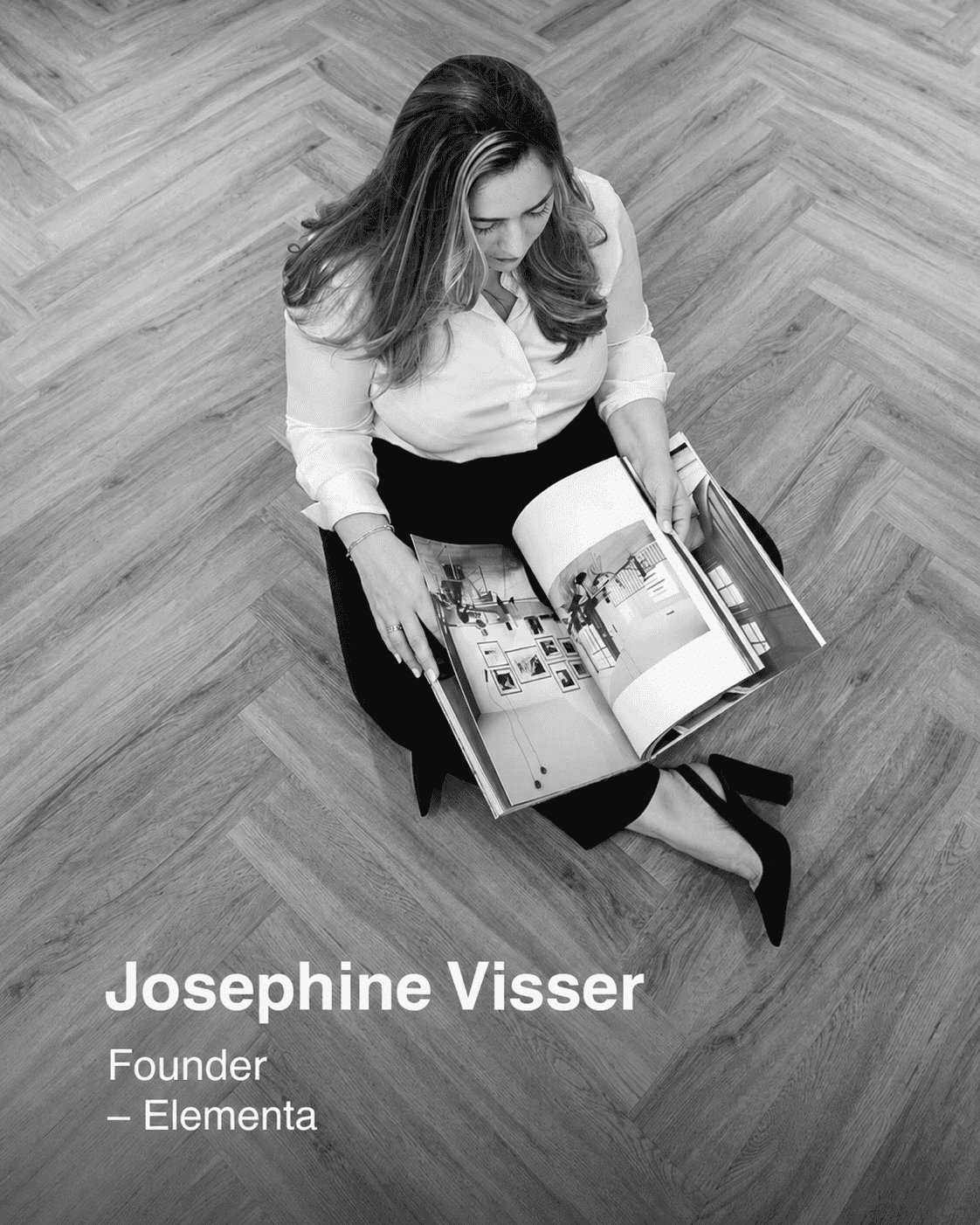Elementa Managing Director Josephine , Elegant woman reading interior design magazine, sitting on wooden floor, promoting Elementa Interior.