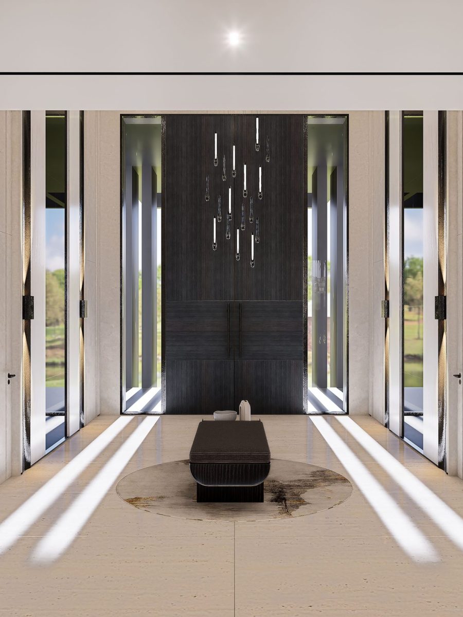 Main entrance of the Jumeirah Golf Estates villa with full-height doors, timber panelling and shafts of daylight