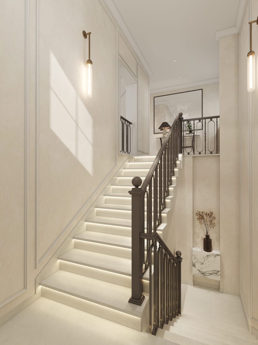 Staircase of the Arabian Ranches villa with lit treads, a dark timber balustrade and wall lights on panelled walls