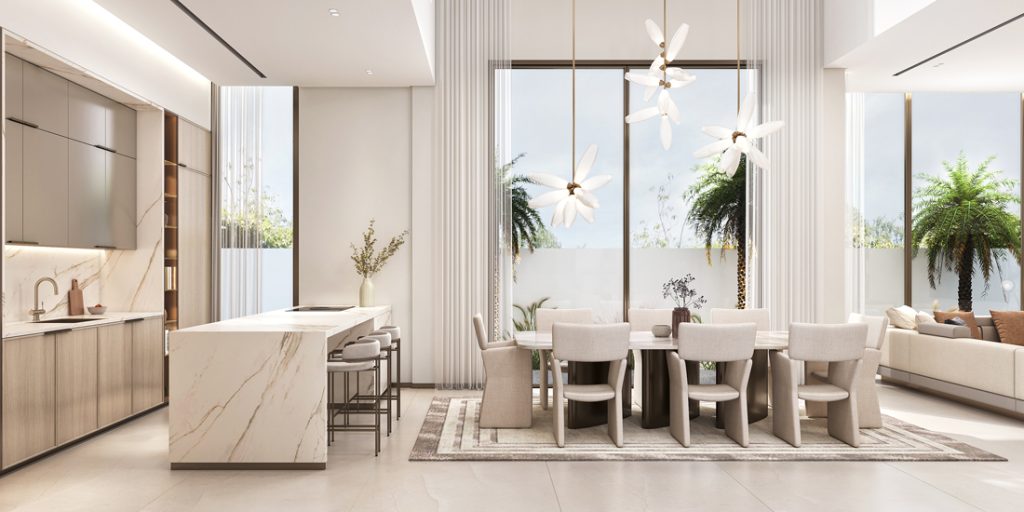 Modern dining and kitchen area with marble island, beige chairs, and large windows.
