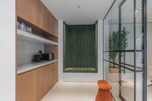 Modern interior design with green accent wall and glass partition at Elementa Interior Design.