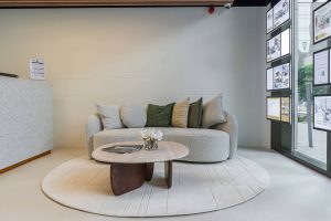 Modern beige sofa with cushions in a stylish interior setting.