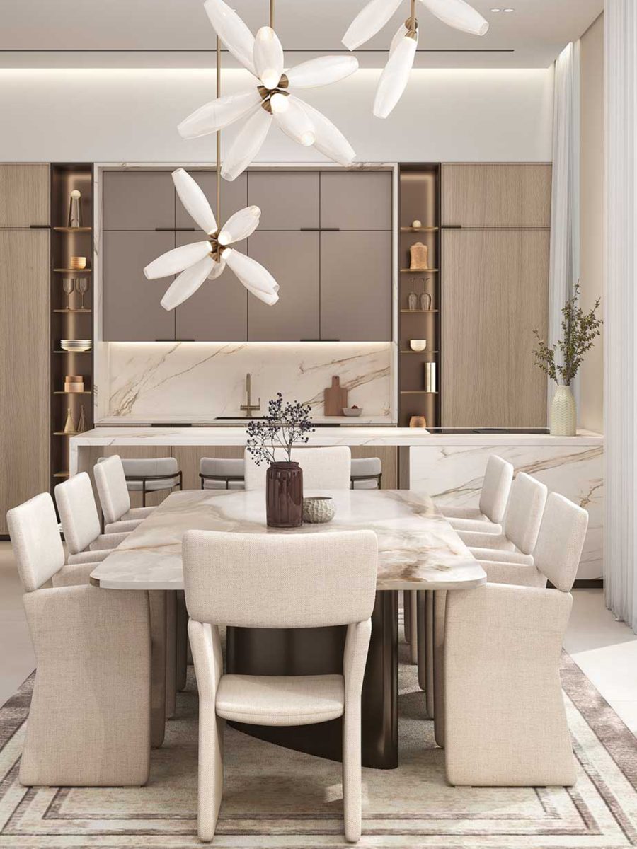Kitchen and dining room of the Nad Al Sheba villa with a marble table, cream chairs and white flower-shaped pendants beside full-height glazing