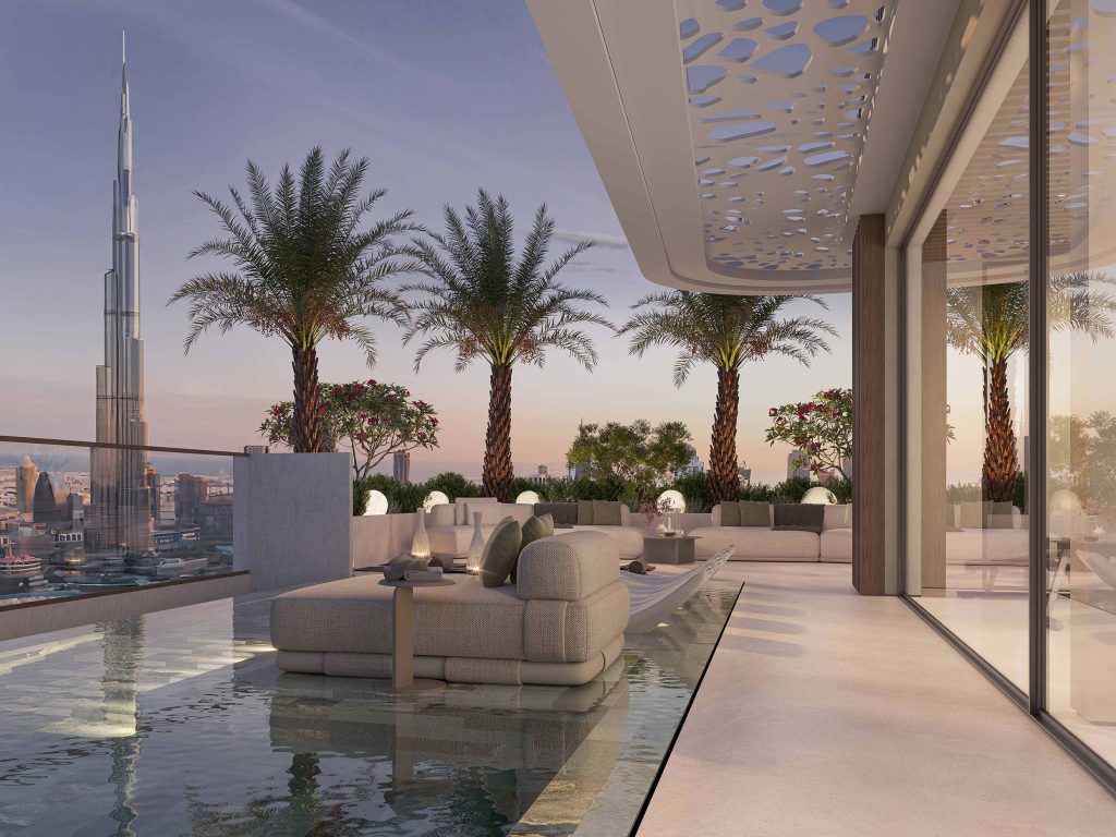 Rooftop pool terrace of Woodland Terraces at dusk with palm trees, lounge seating and the Burj Khalifa on the skyline