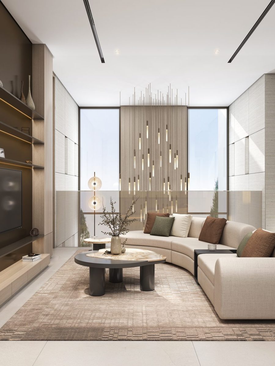 First-floor family living room of the Nad Al Sheba villa with a curved sofa, a stone feature wall and a view to the garden